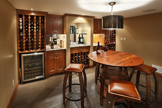 basement bar setting with cherry wood table and stools