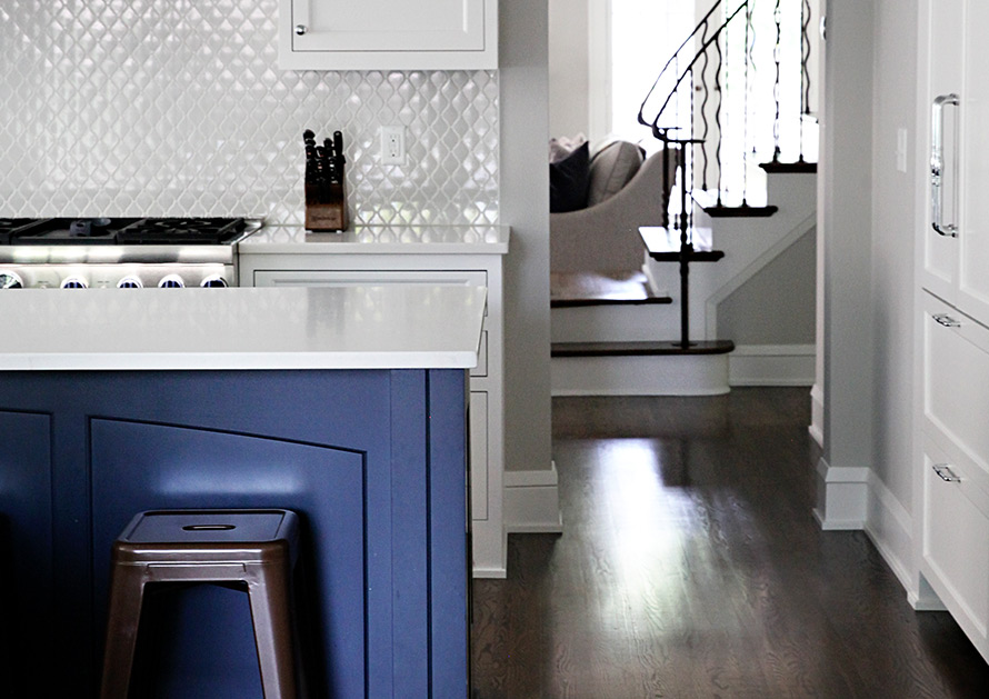 Bella Homes Kitchen Island with wall tile purple cabinets