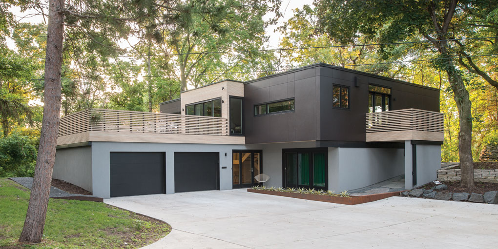 A picture of a modern, two-story home with a renovated exterior.