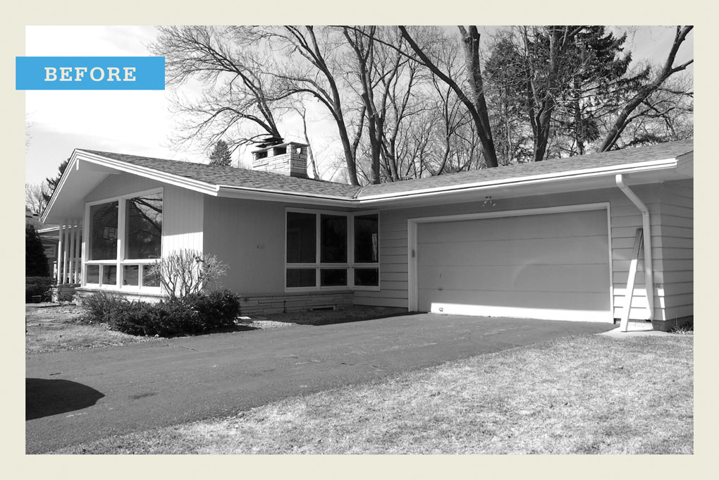 A black-and-white "before" photo of rambler that featured large bay windows and attached garage.