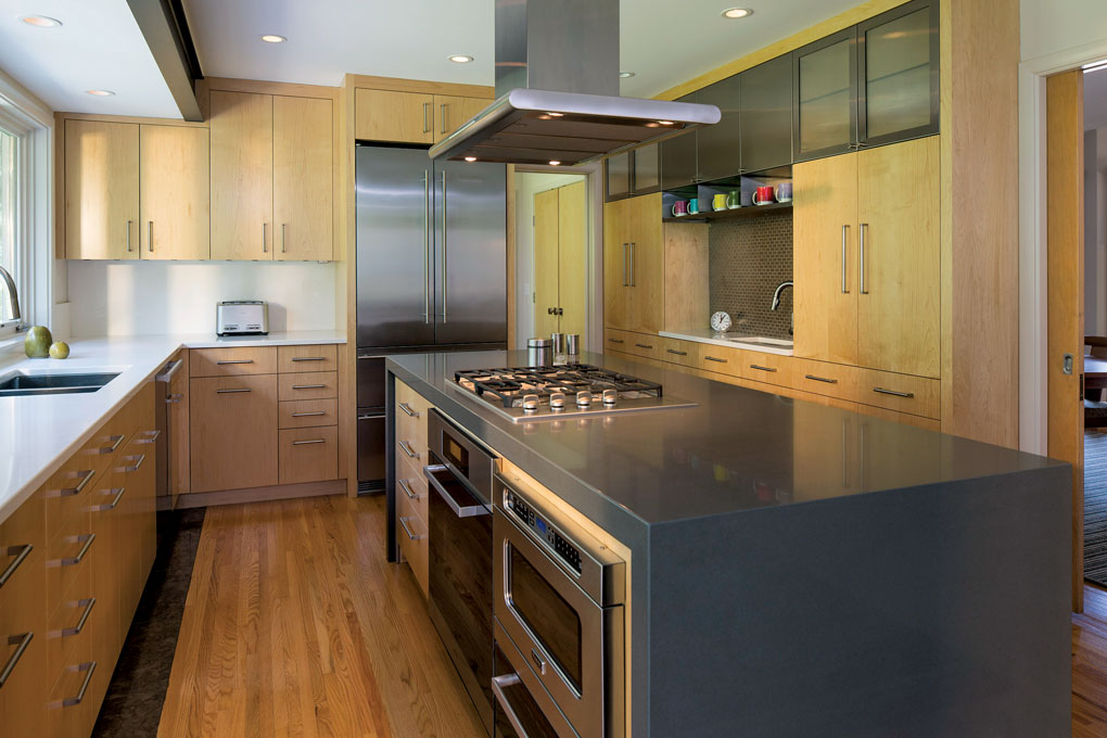 Light wood floors and cabinetry are accented by stainless steel appliances and a large center island.