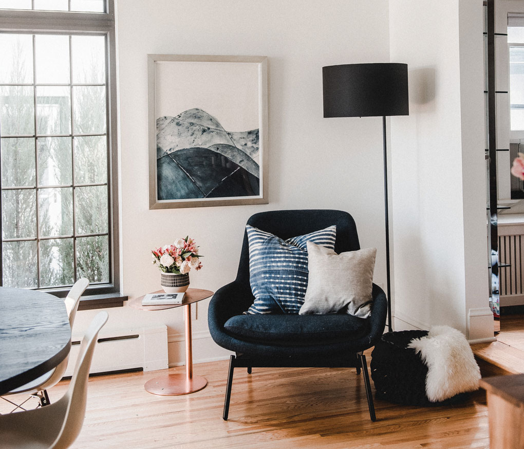 The repurposed dining room added a cozy corner complete with blue chair and small table.