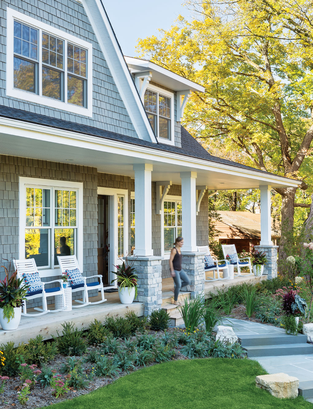 The exterior of a Lake Minnetonka home features an old-fashioned sitting porch and an East Coast-inspired look.