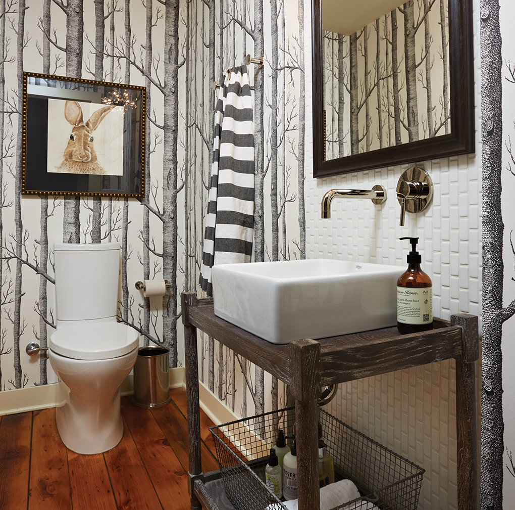 A rabbit portrait by Bonnie Folkerts displayed in a bathroom.