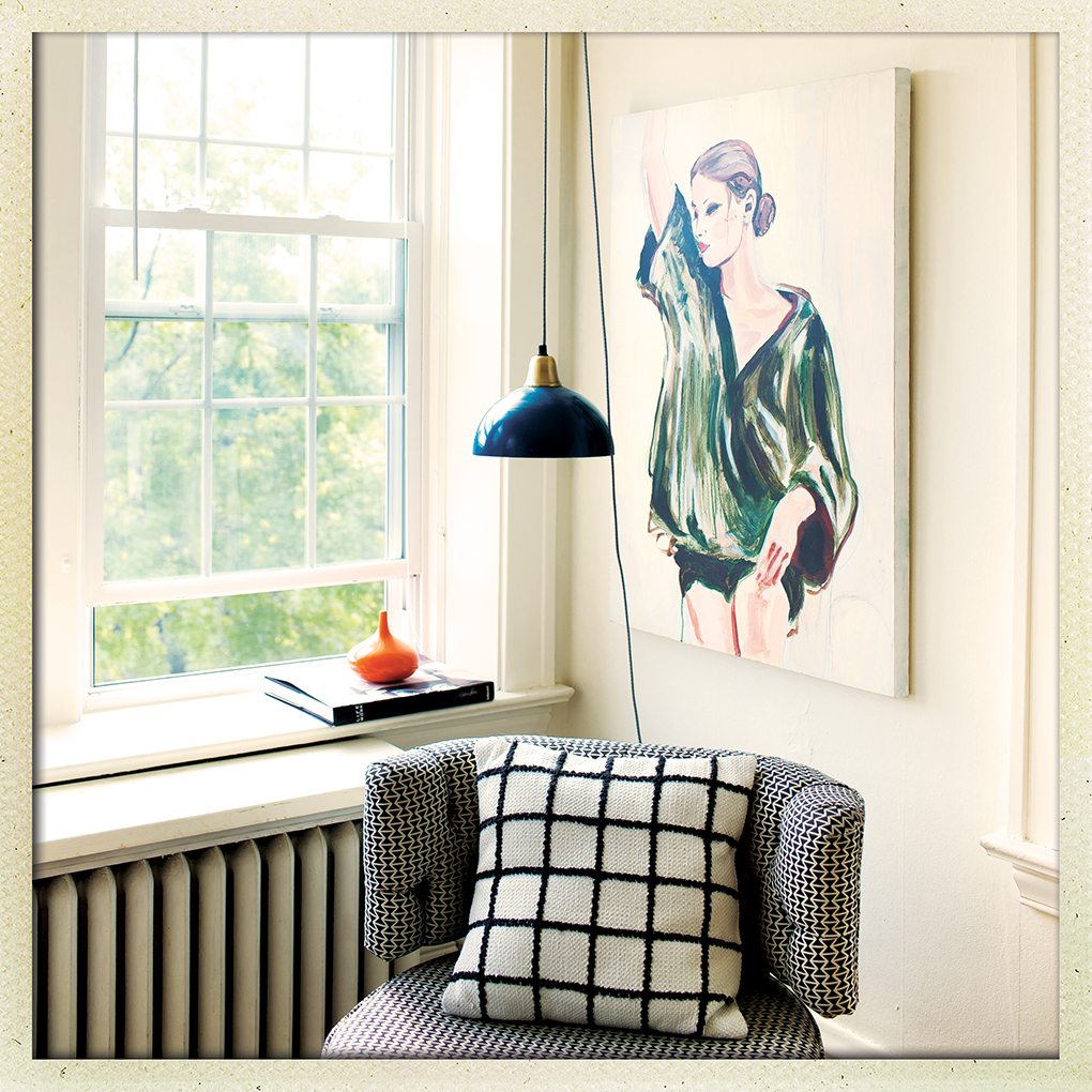 A vintage chair sits underneath a painting of a woman next to a window in a living room.