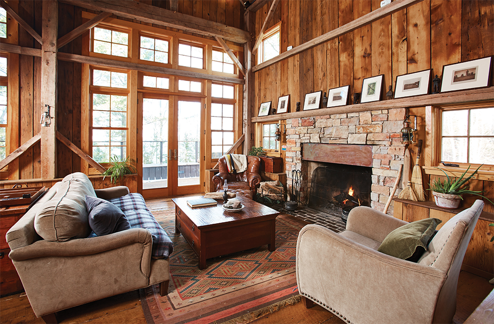 Chairs inside wooden cabin with fireplace