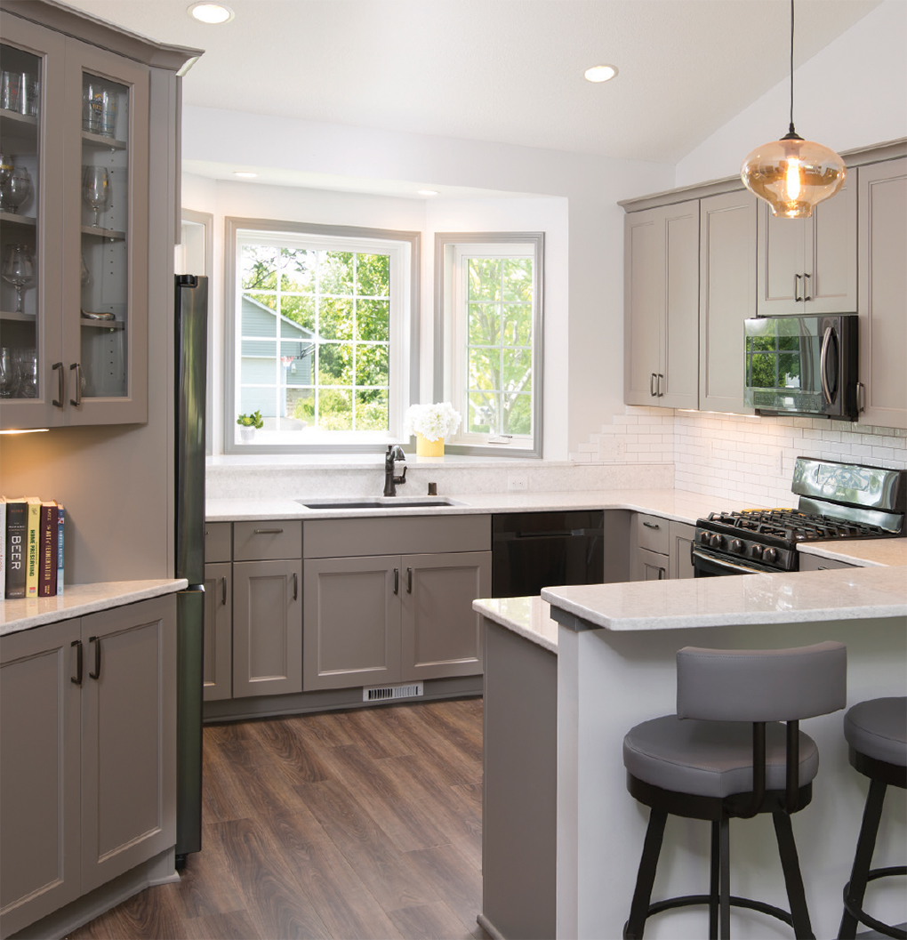 Grey and white kitchen with white countertops and grey accent furniture 