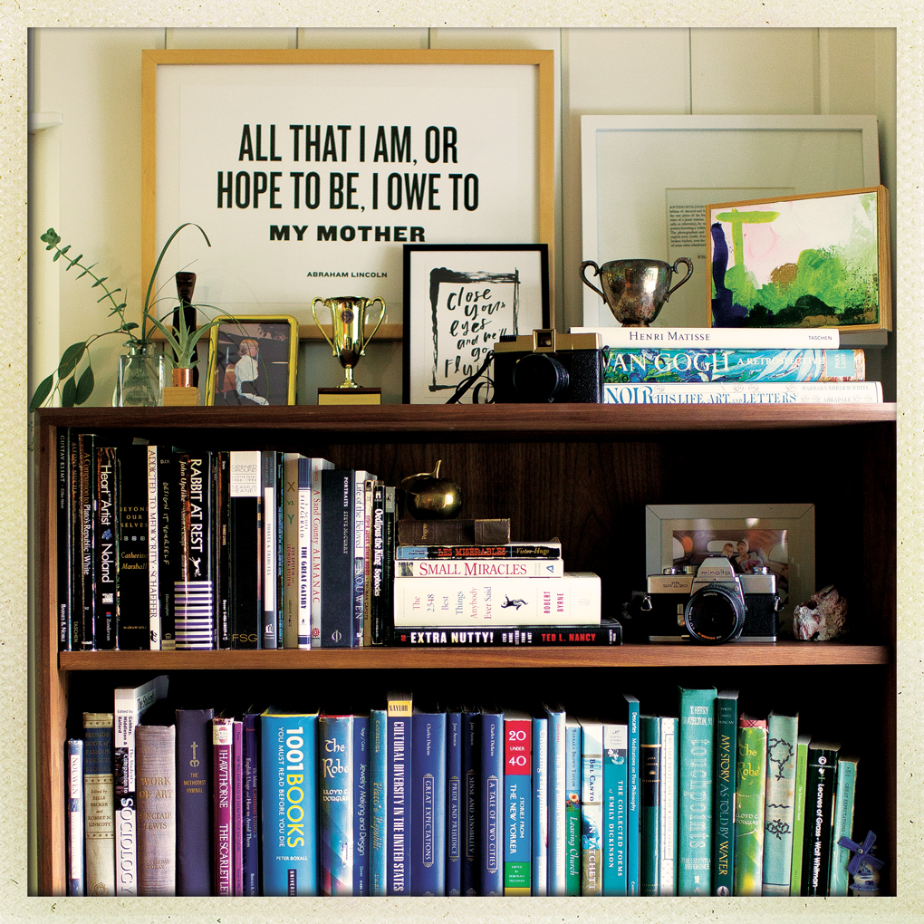 Framed lyrics on top of a bookshelf.