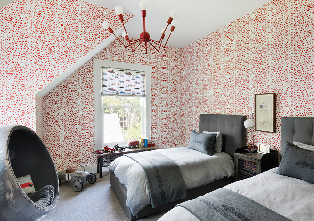 A boys bedroom with two beds, and toys on the floor.