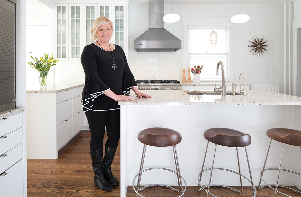 Architect Jackie Millea in a St. Paul kitchen she remodeled, redesigning a long, narrow space into a light-filled, functional cook’s kitchen. 