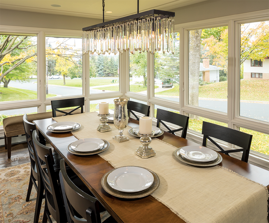 The remodel transformed a once-gloomy porch into this window-wrapped dining room. 