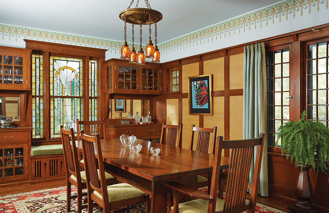 Designed by David Heide Design Studio, the dining room’s oak paneling and molding was restored according to Ellerbe’s original drawings. The cabinetry, art-glass windows and sidelights, and stenciling emphasize the room’s historic style.