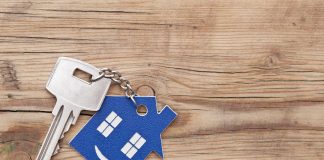 Keys on a wooden background after selling your house.