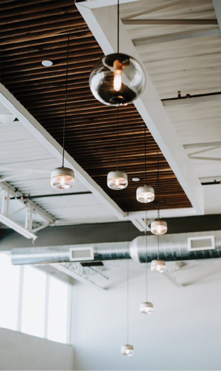 Glass pendants by Hennepin Made hanging from the ceiling.