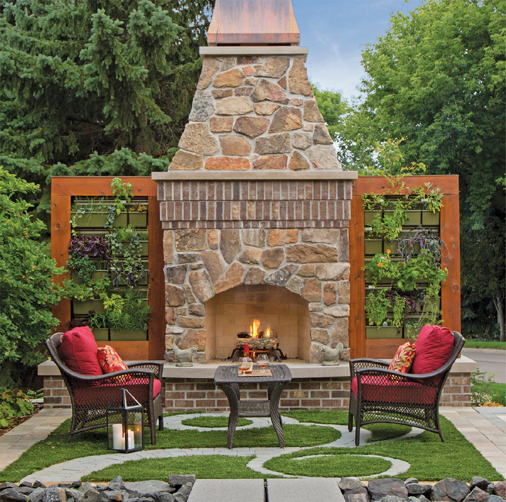 Living walls of herbs and vegetables frame the outdoor fireplace.