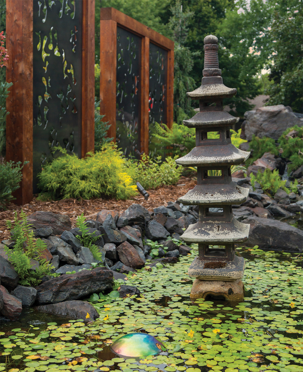 Statues and lanterns imported from Bali reflect the homeowners’ affinity for the Indonesian paradise.