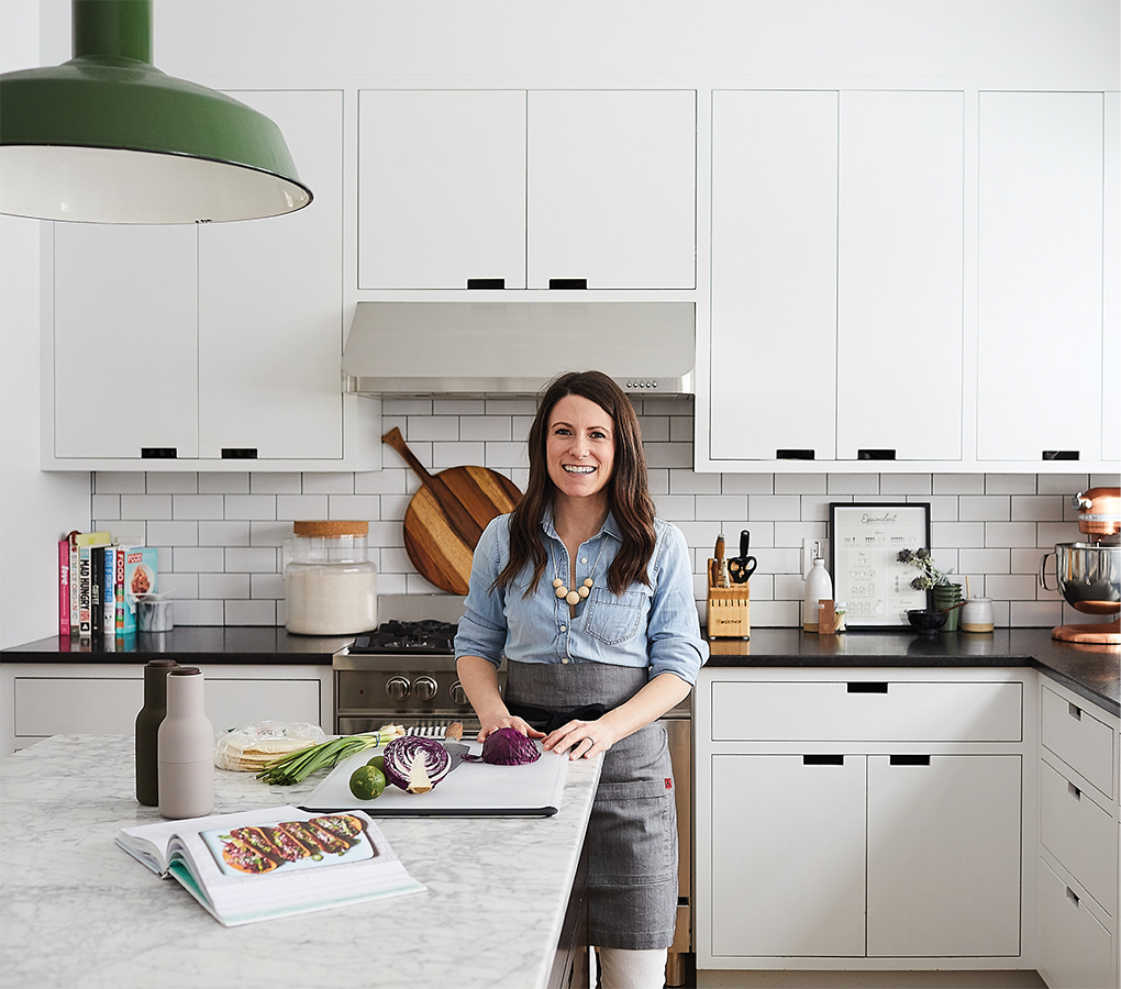 Melissa Coleman’s kitchen features neatly organized drawers and minimal cabinets with notches in place of pulls.