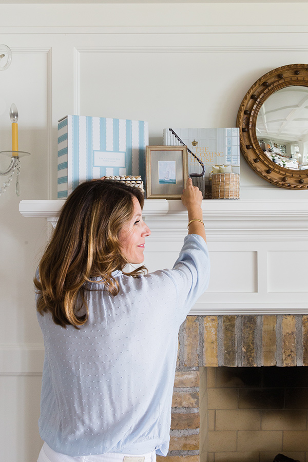 Heather Strommen placing a vignette box on a mantle.