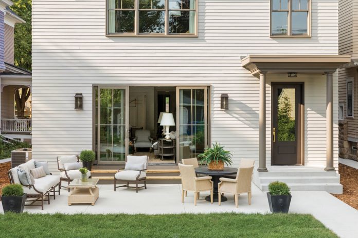 The exterior of a home showing a patio with seating on Midwest Home's 2018 Luxury Home Tour.