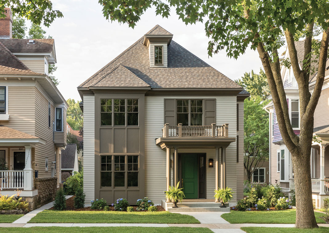 Designed to seamlessly blend in among its historic neighbors, the new home’s exterior features double-hung windows and a front portico topped by a balustrade. Part of Midwest Home's 2018 Luxury Home Tour.