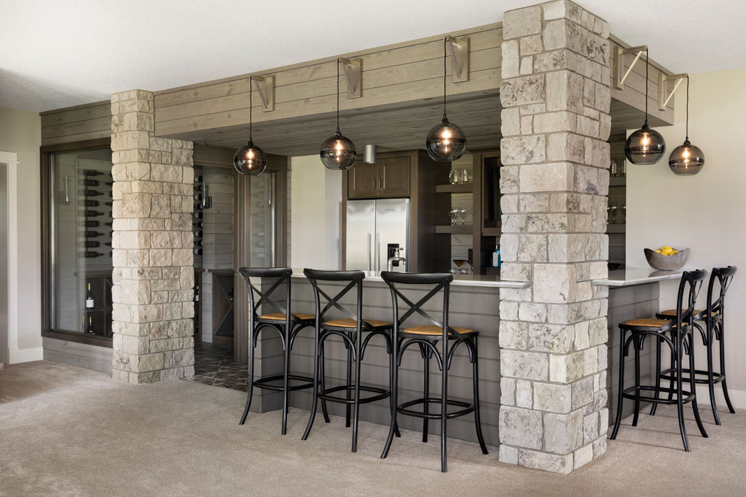 The same stone accents are found in the lower-level bar. Part of Midwest Home's 2018 Luxury Home Tour.