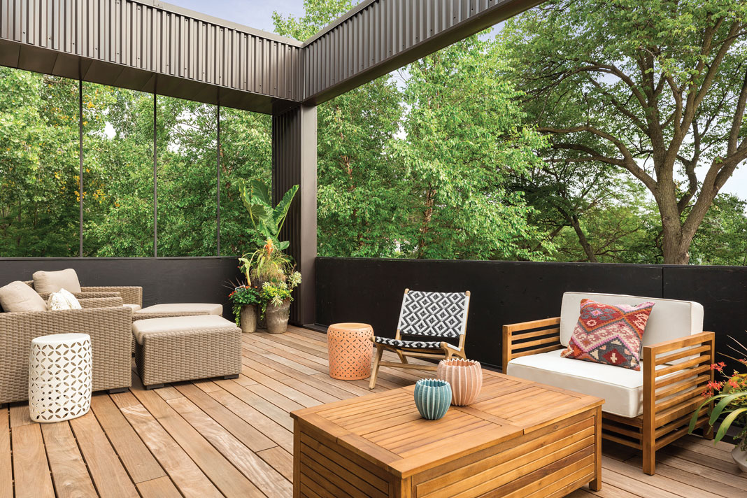 Located off the living room, the balcony features ipe wood decking, a variety of seating options, and a live-edge roof feature. Part of Midwest Home's 2018 Luxury Home Tour.