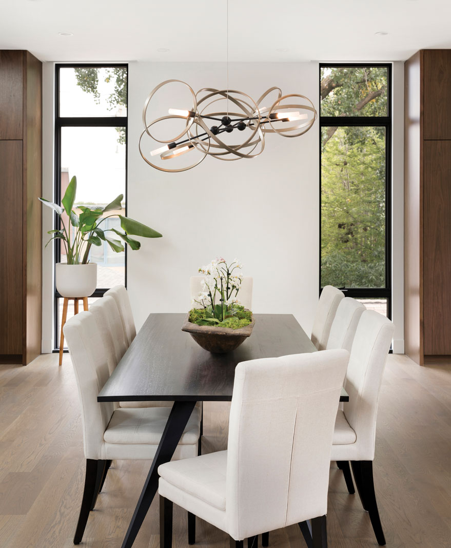 In the main living area, the home’s formal dining table sits beneath a contemporary chandelier, in tune with the condo’s urban atmosphere. Part of Midwest Home's 2018 Luxury Home Tour.