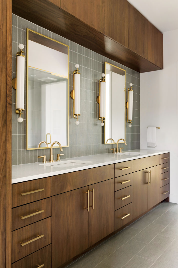 Gold accents add a touch of glam to the natural wood cabinetry used in the master bathroom. Part of Midwest Home's 2018 Luxury Home Tour.