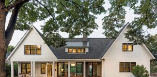 The exterior of a home, to which, upon arrival, guests are met with an inviting front porch tucked beneath one of the home’s two distinctive gabled pavilions. Part of Midwest Home's 2018 Luxury Home Tour.
