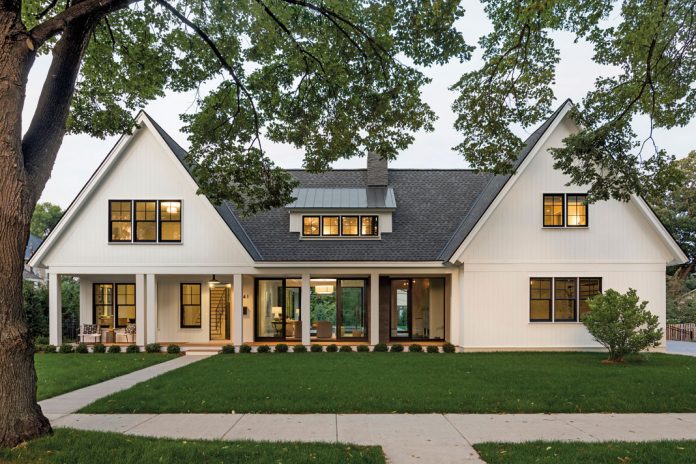 The exterior of a home, to which, upon arrival, guests are met with an inviting front porch tucked beneath one of the home’s two distinctive gabled pavilions. Part of Midwest Home's 2018 Luxury Home Tour.