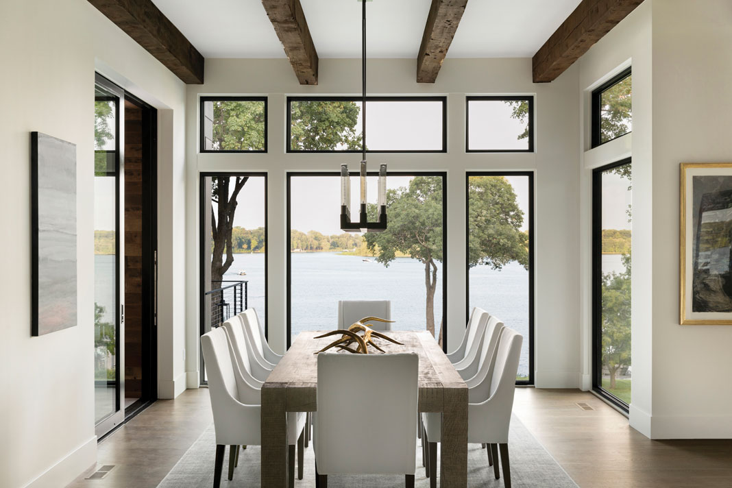 In the dining area, floor-to-ceiling windows provide sprawling views of Maxwell Bay. Part of Midwest Home's 2018 Luxury Home of Tour.