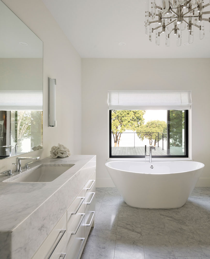 Upstairs, the master bath features elements of stone in its two vanities, along with a strategically placed soaking tub with optimal views of Lake Minnetonka. Part of Midwest Home's 2018 Luxury Home Tour.