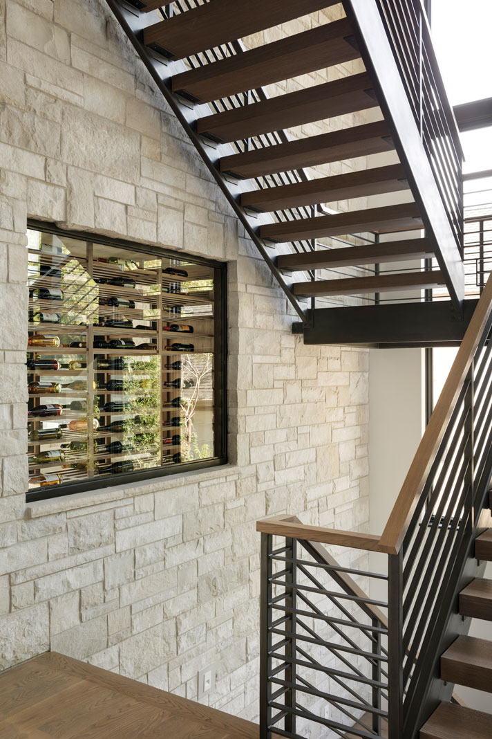 A steel staircase with thick wood treads connects all three of the home’s levels, once more combining modern elements with natural materials in a perfect medley of style. Part of Midwest Home's 2018 Luxury Home Tour.