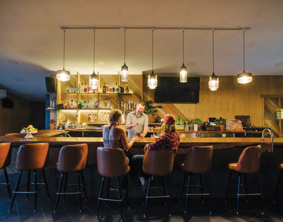 The bar with people sitting at it in the Poplar Haus on the Gunflint Trail.