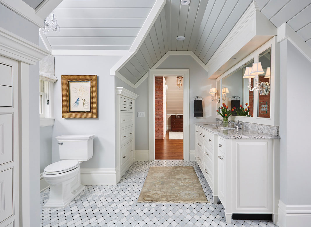 An all white bathroom a double sink vanity, marble shower, mosaic flooring, and heated floors.