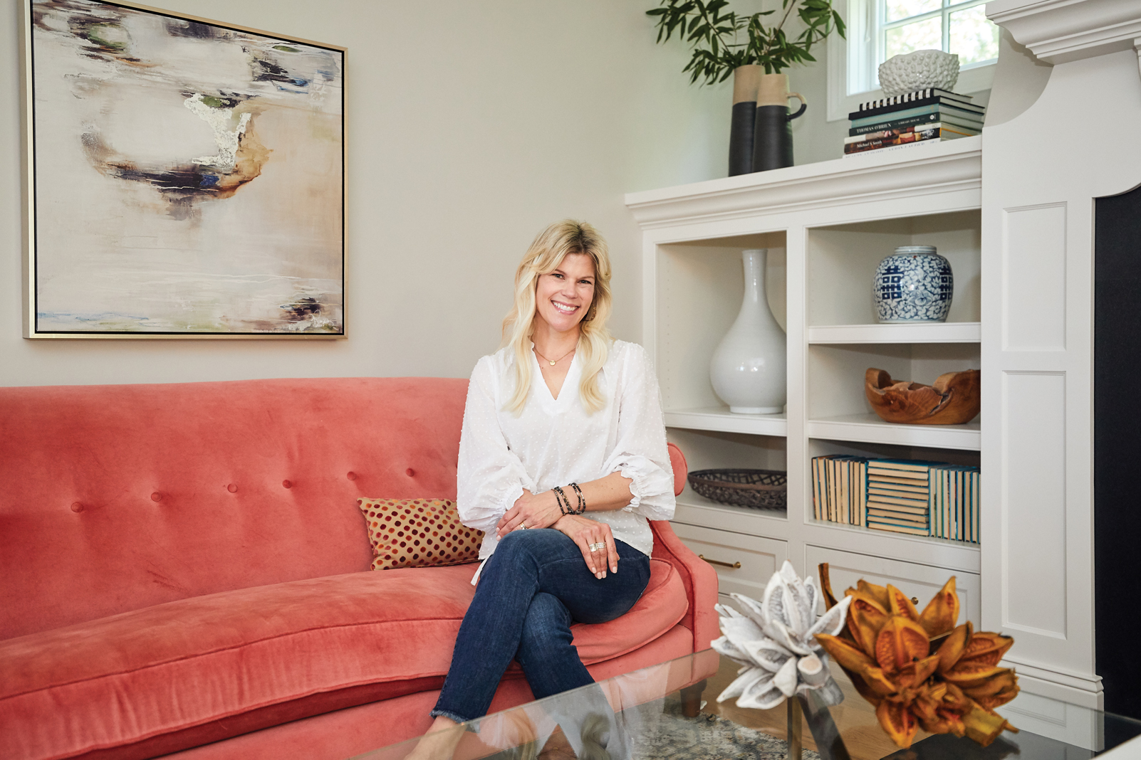 Renae Keller perches on her newly reupholstered sofa, the first “big girl” purchase she ever made and a piece she’s kept for nearly 20 years.